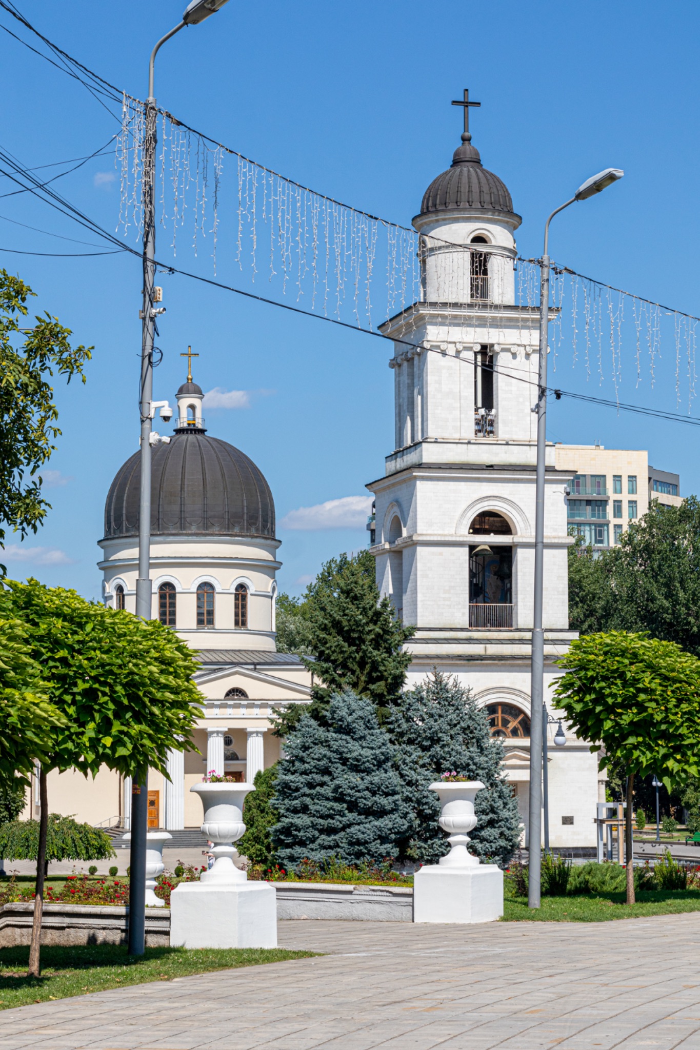 Orthodox church with bell tower on a sunny day, surrounded by greenery in an urban setting in Chisinau, Moldova.