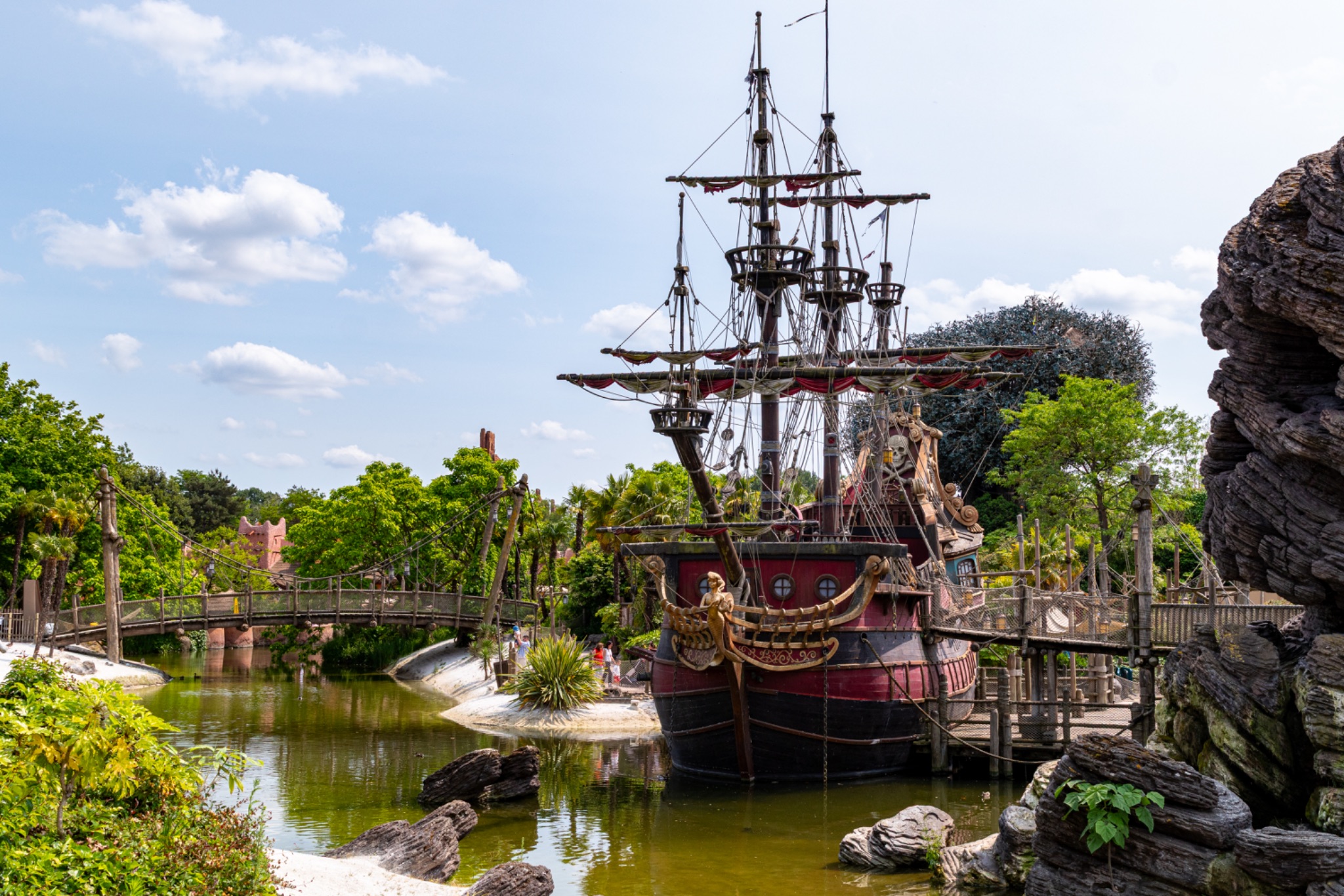 Docked Tall Ship with Bridge over Waterway at Disneyland Paris.