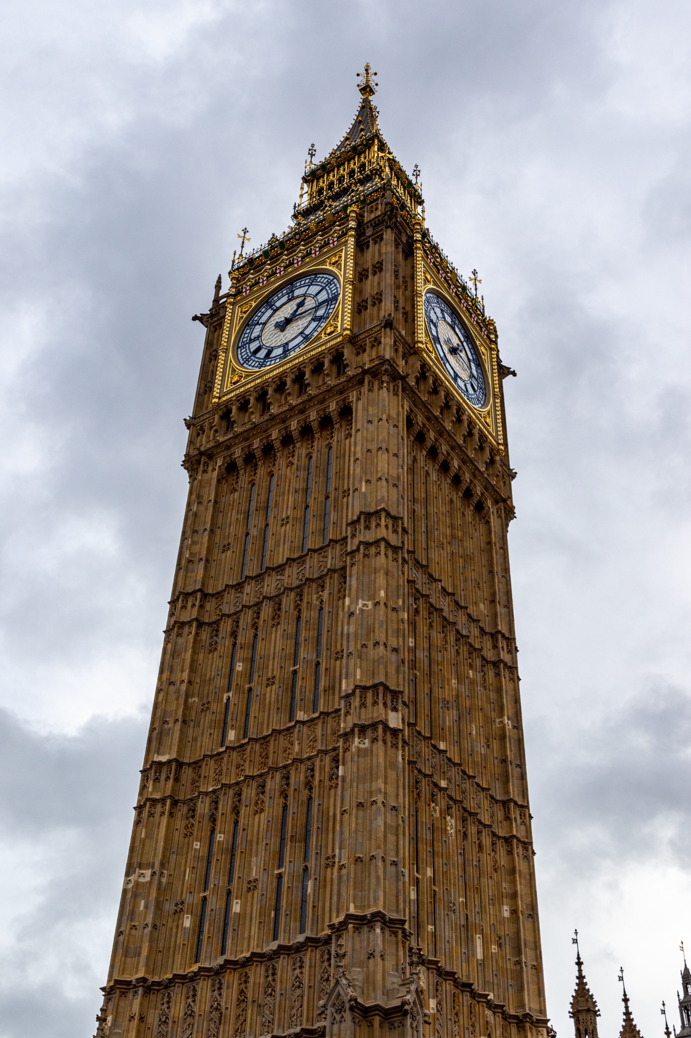 Iconic Big Ben clock tower under a cloudy sky in London, England, symbolizing British culture and architecture.