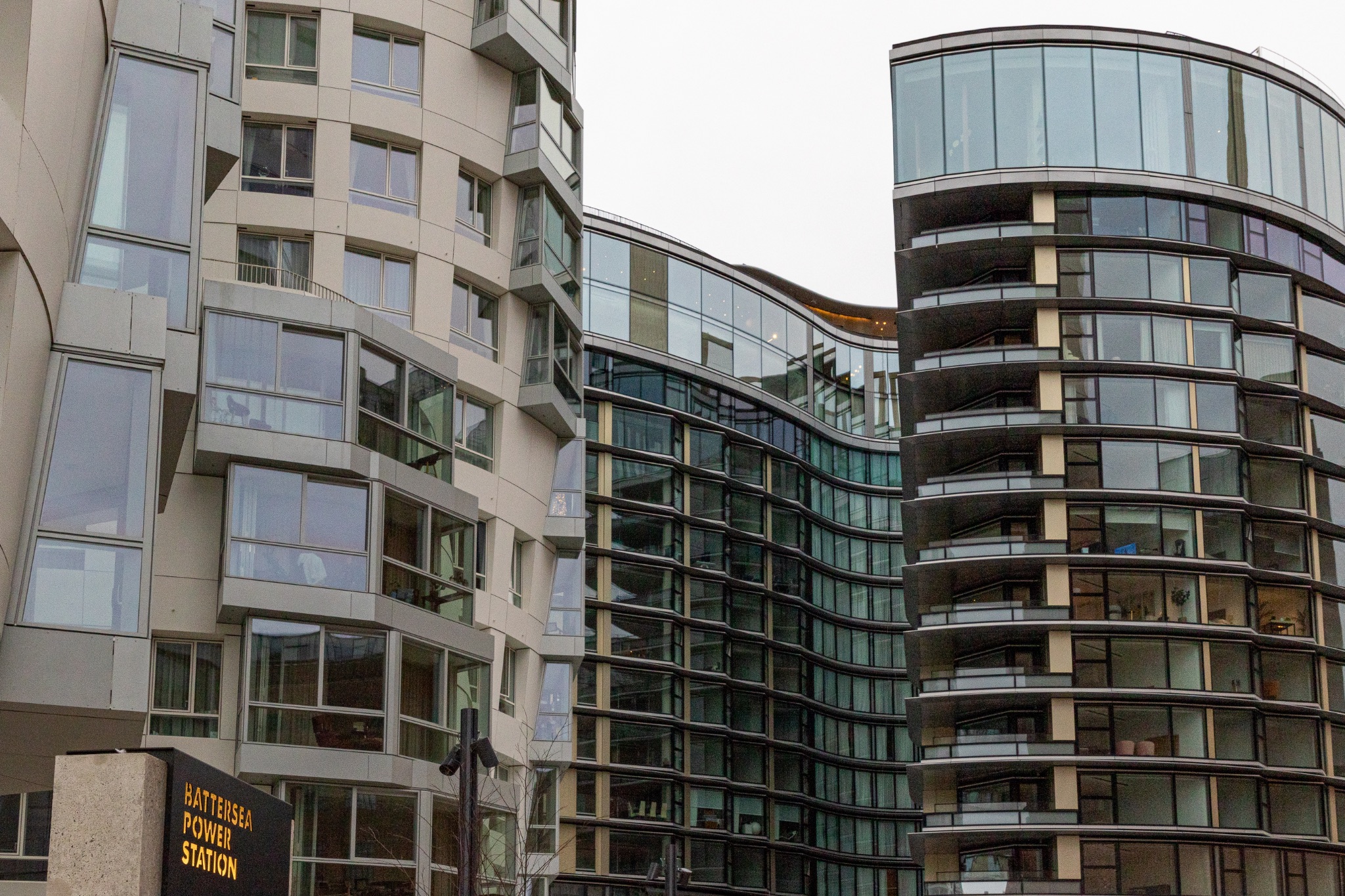 Modern urban architecture with a mix of glass facade and traditional buildings.