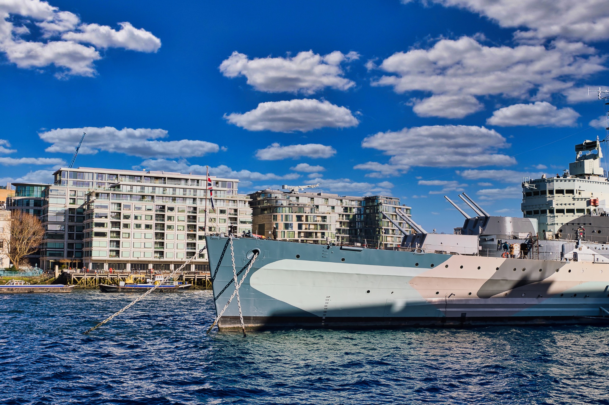 Warship Moored near Modern Buildings, London