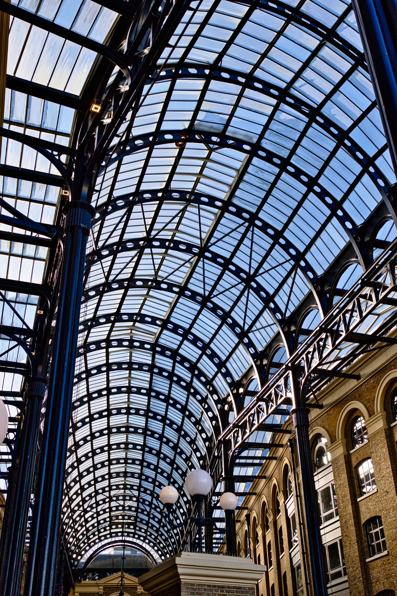 Arched Glass and Metal Roof Structure with Lighting Fixtures in London, UK.