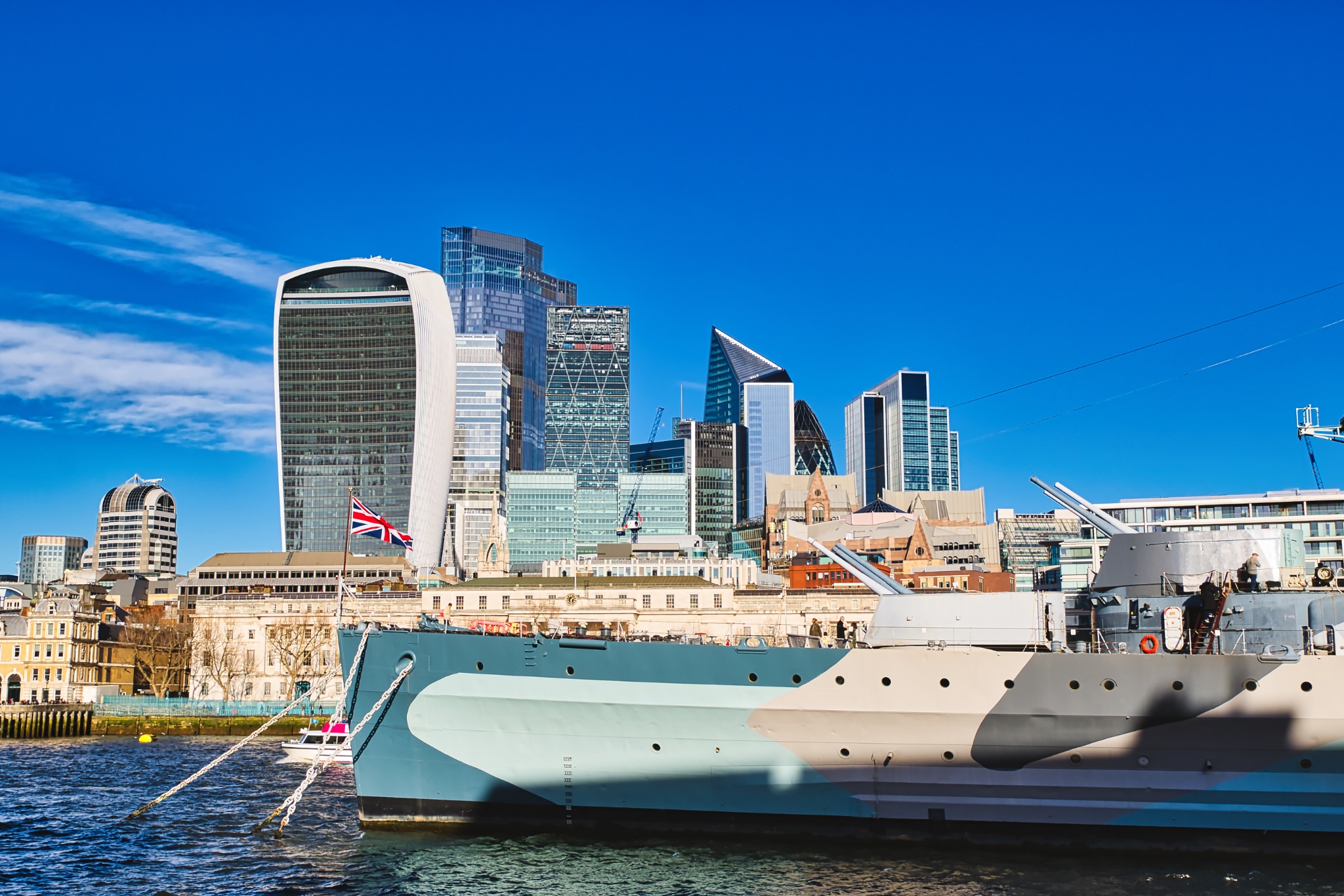 Warship Docked in London with City Skyline