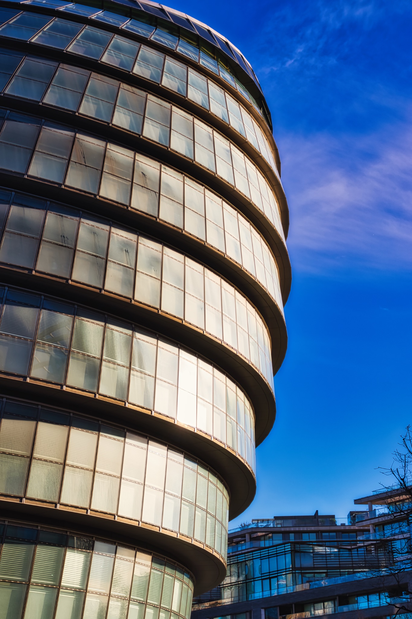 Modern Glass Building Facade and Adjacent Structure in London, UK.