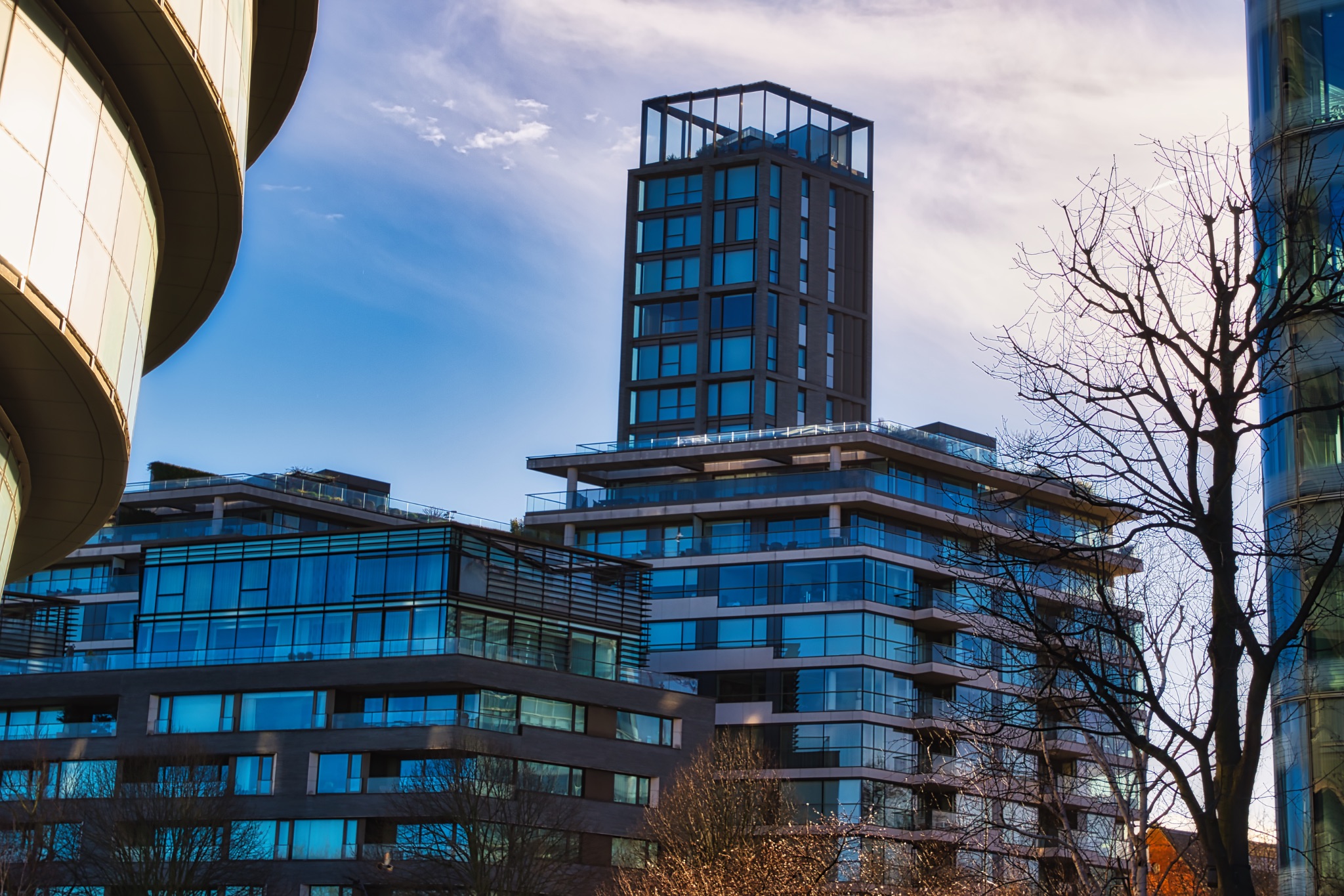 Modern Apartment Buildings with Glass Facades and Central Tower in London, UK.