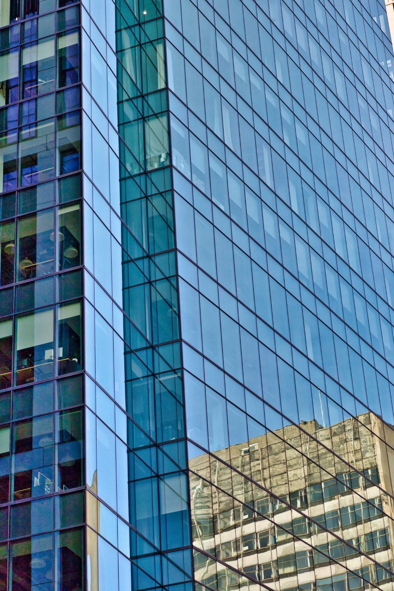 Glass Facade of Modern Skyscraper Reflecting Older Building in London, UK.
