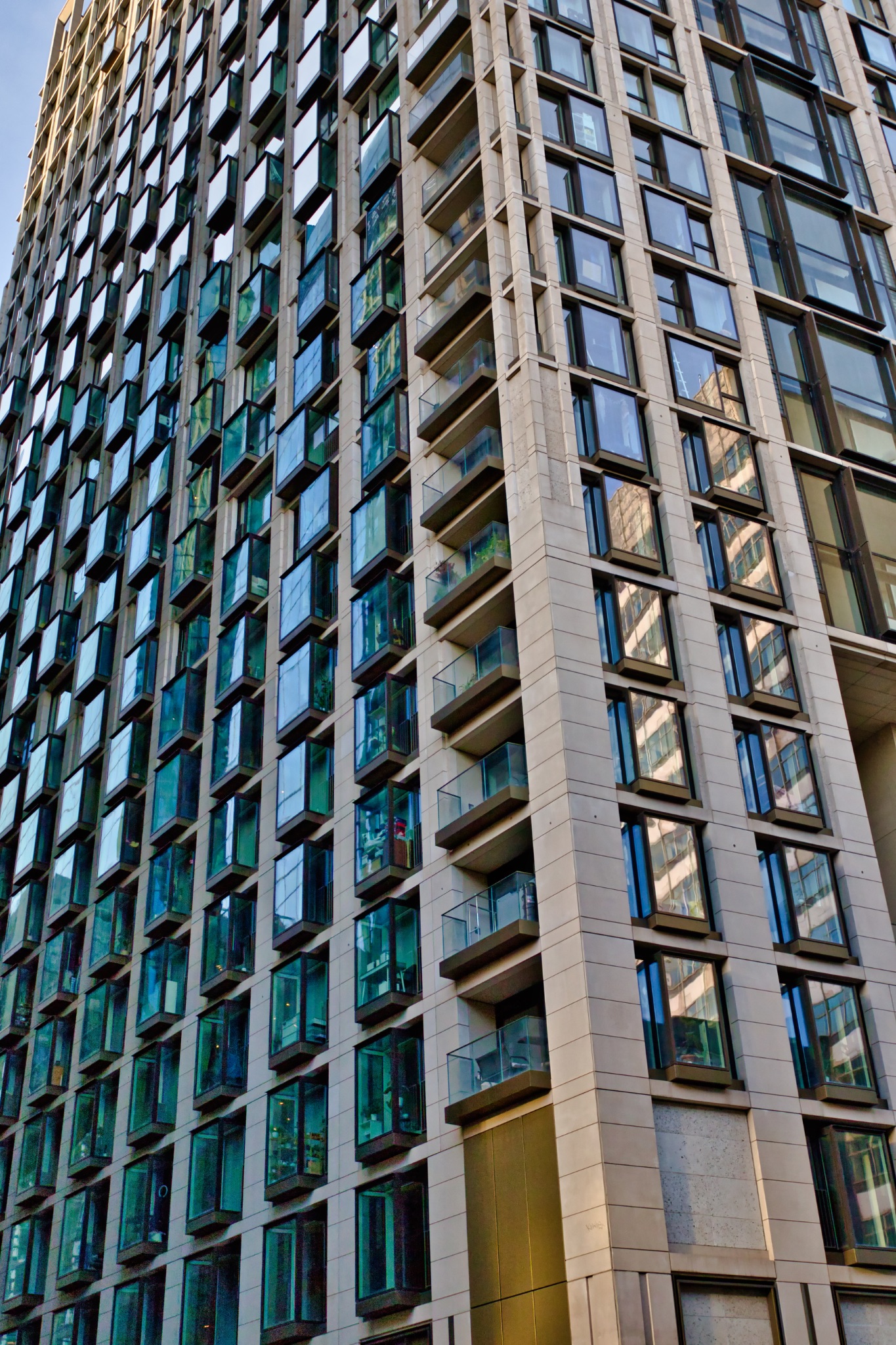 High-Rise Residential Building with Balconies and Teal Windows in London, UK.