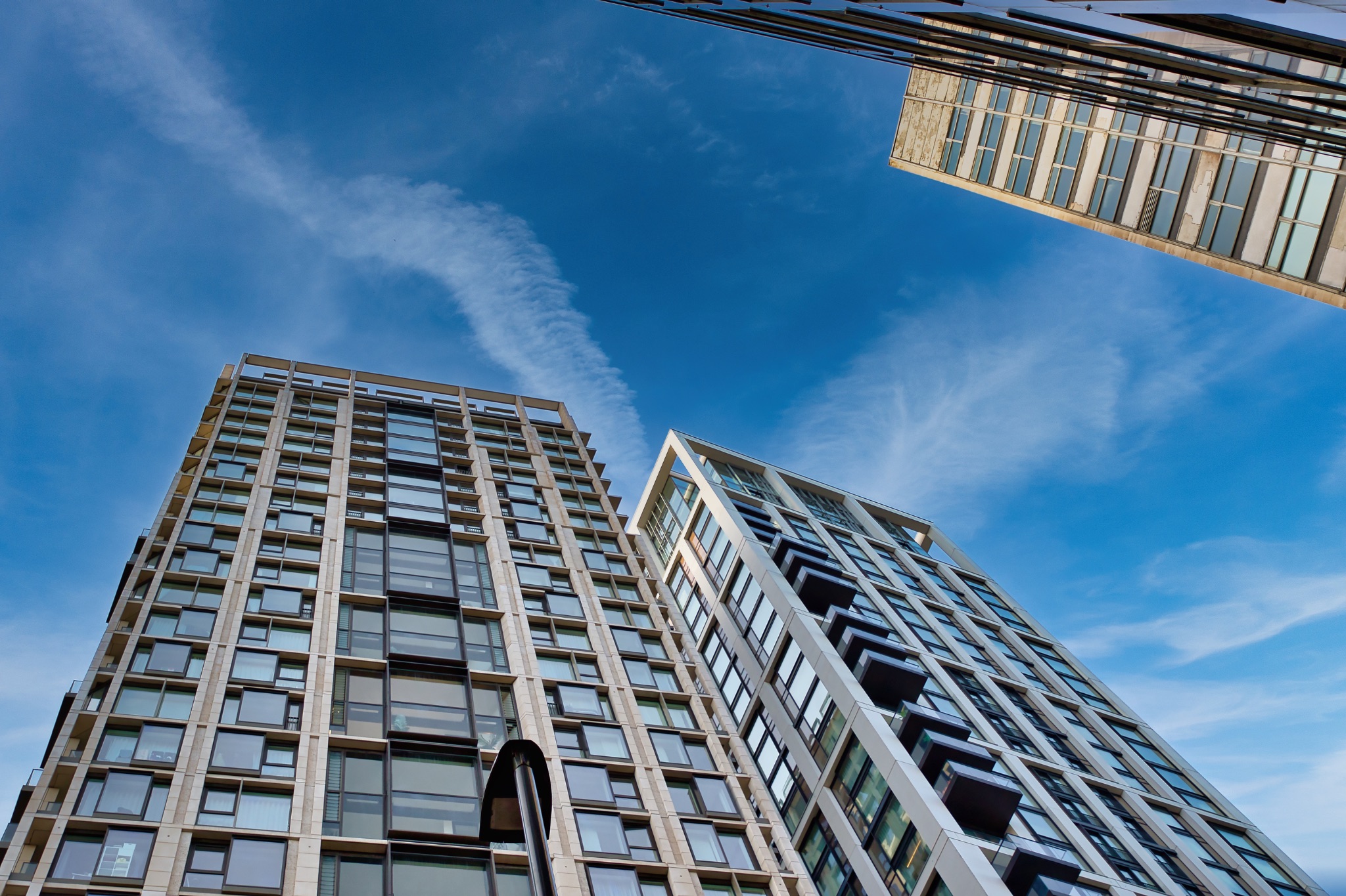 Three Modern High-Rise Buildings Under a Blue Sky in London, UK.