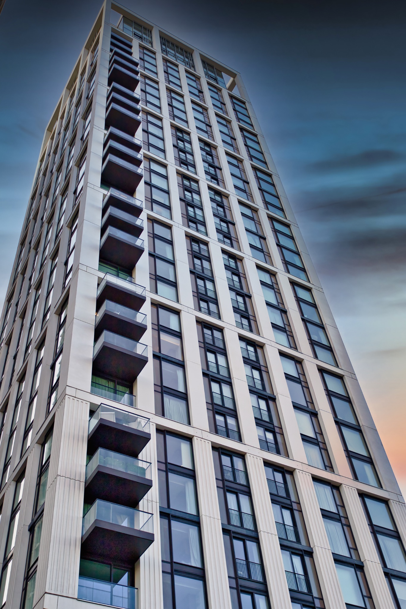 High-Rise Residential Building with Balconies and Windows at Dusk in London, UK.