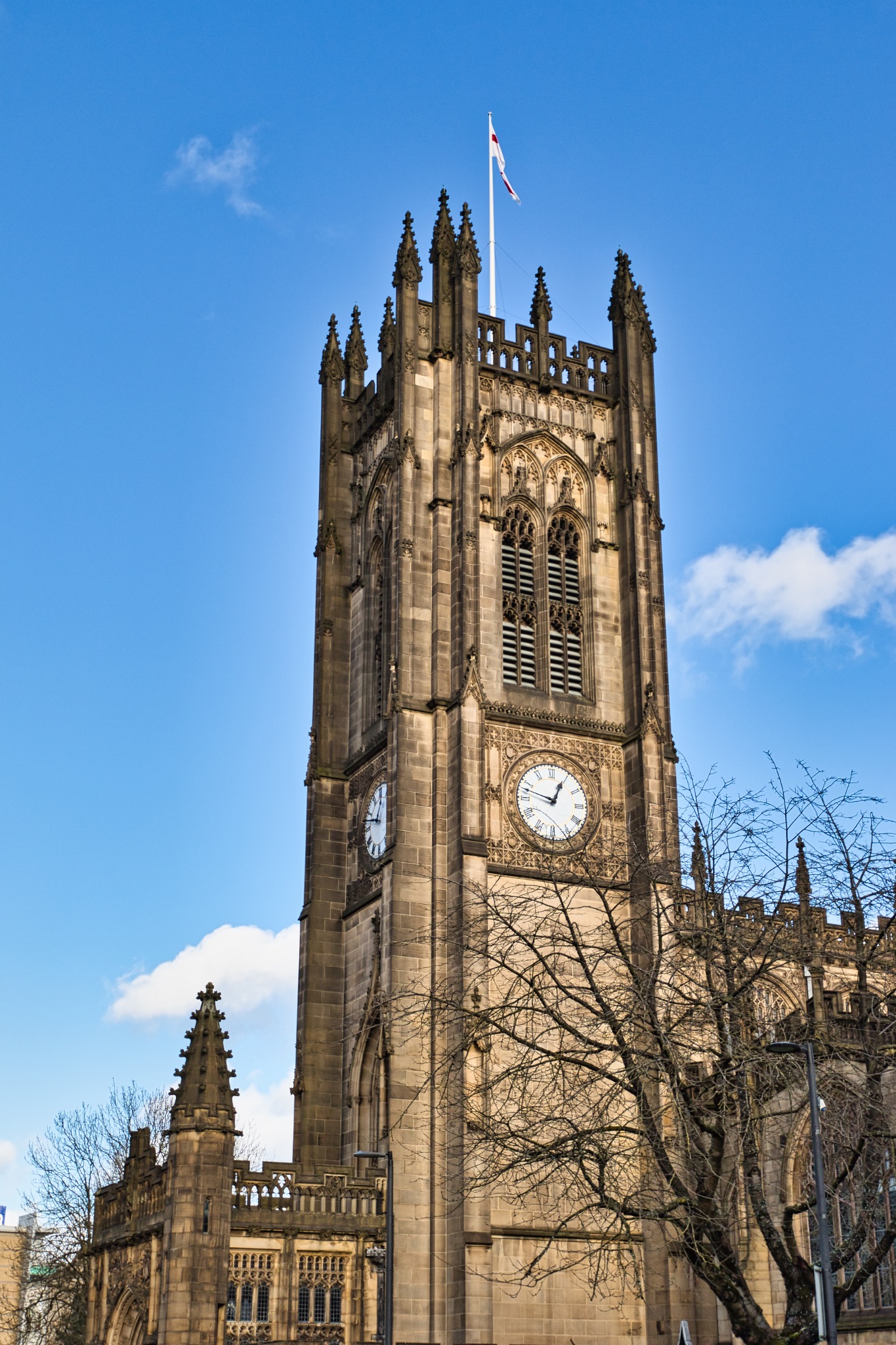 Liverpool Cathedral Tower, Clock, and Flag in Manchester, UK.