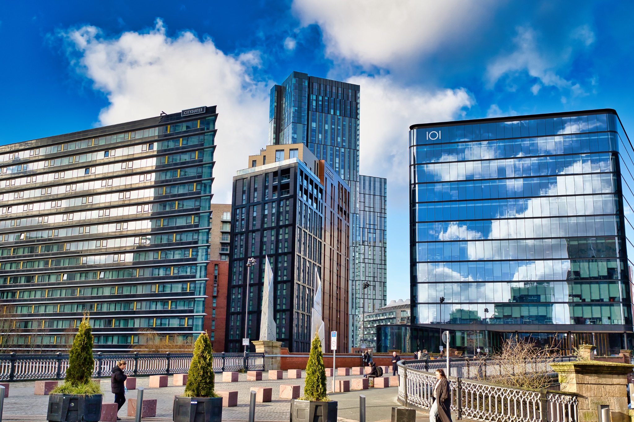 Cityscape with Modern High-Rise Buildings and Pedestrian Bridge in Manchester, UK.