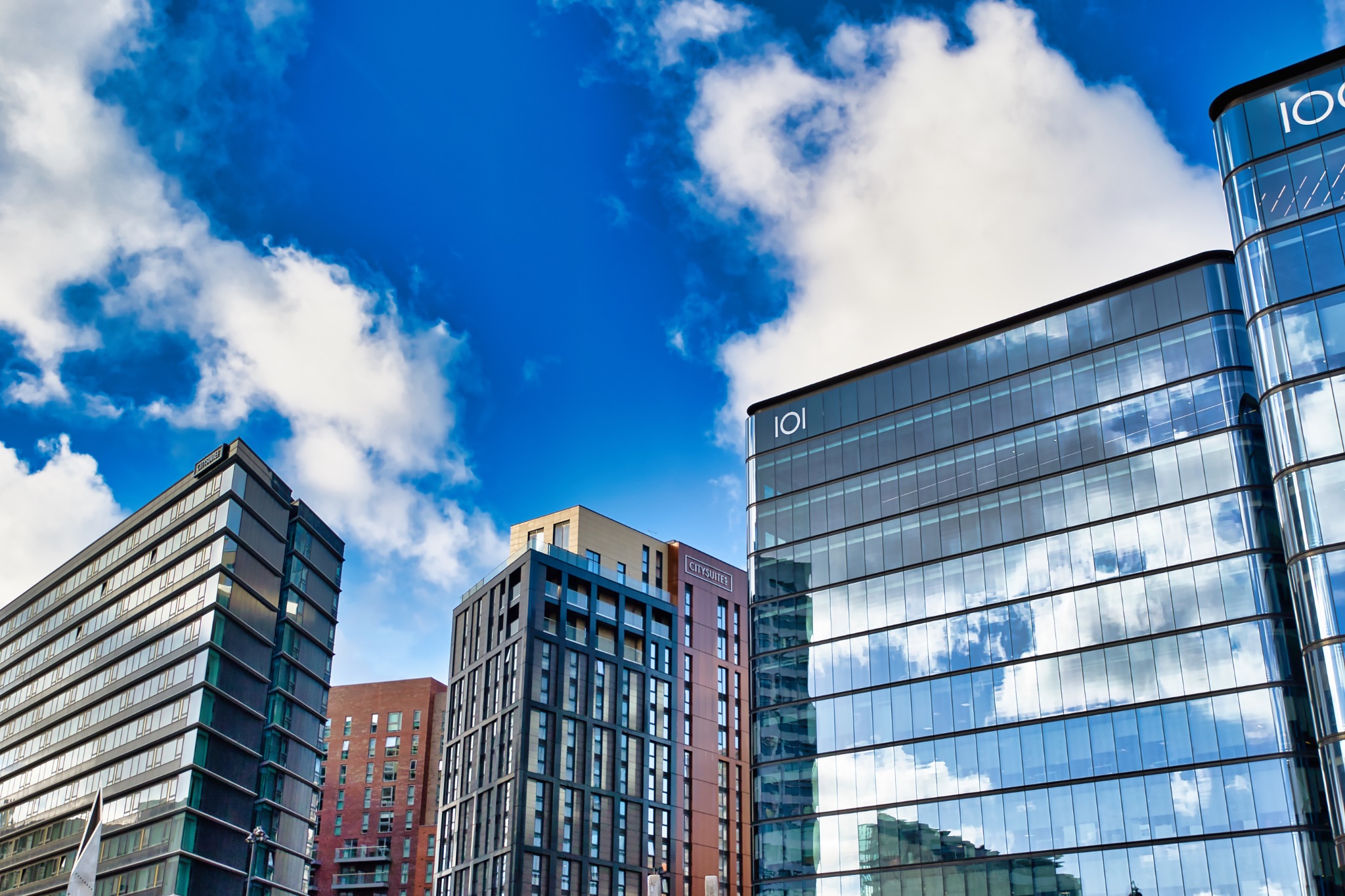 Modern Buildings and Blue Sky with Clouds in Manchester, UK.