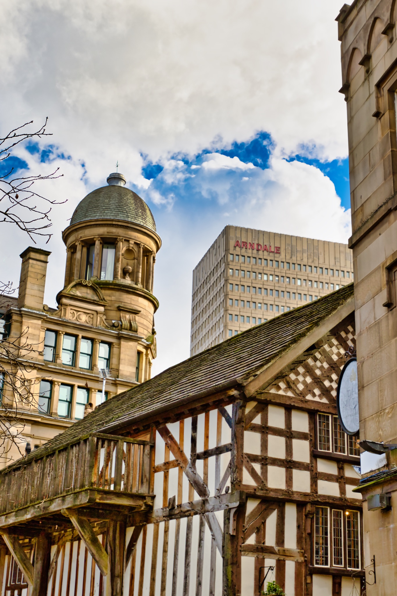 Architectural Details: Half-Timbered Building, Domed Structure, and Modern Office Block in Manchest