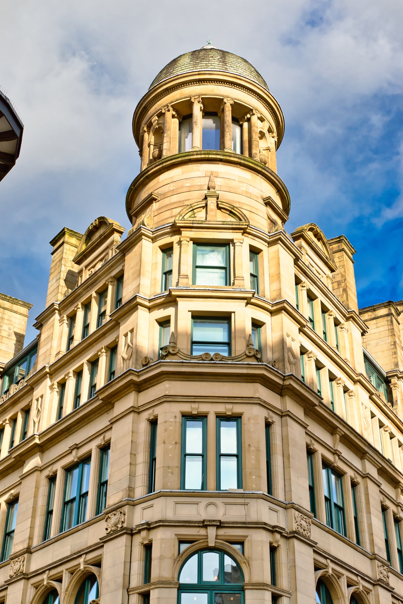 Corner Building with Dome Turret and Multi-Paned Windows in Manchester, UK.