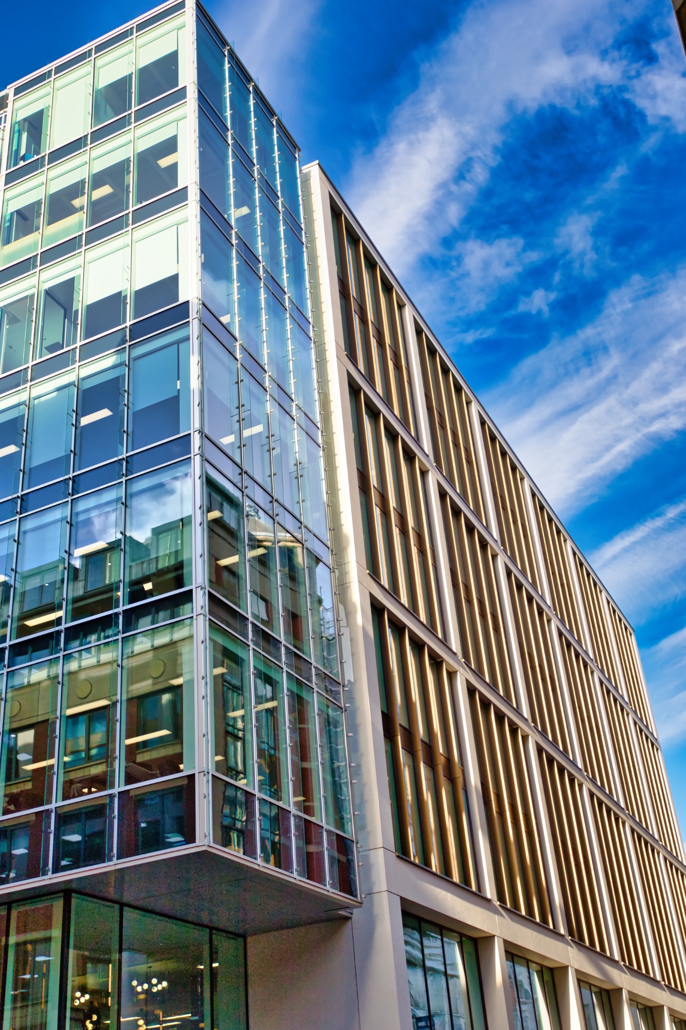 Modern Office Building with Glass and Bronze Facade in Manchester, UK.