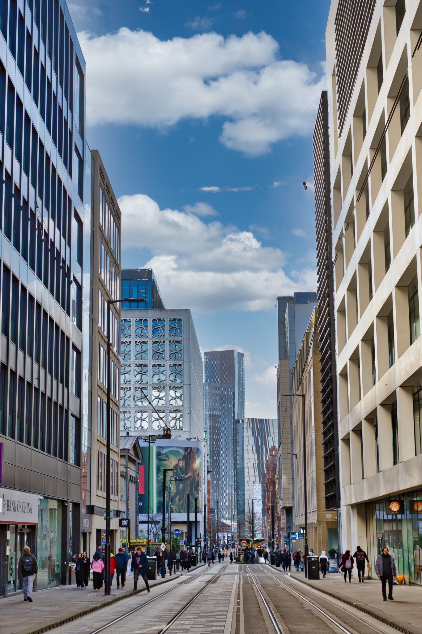Modern City Street with Tram Tracks and High-Rise Buildings in Manchester, UK.