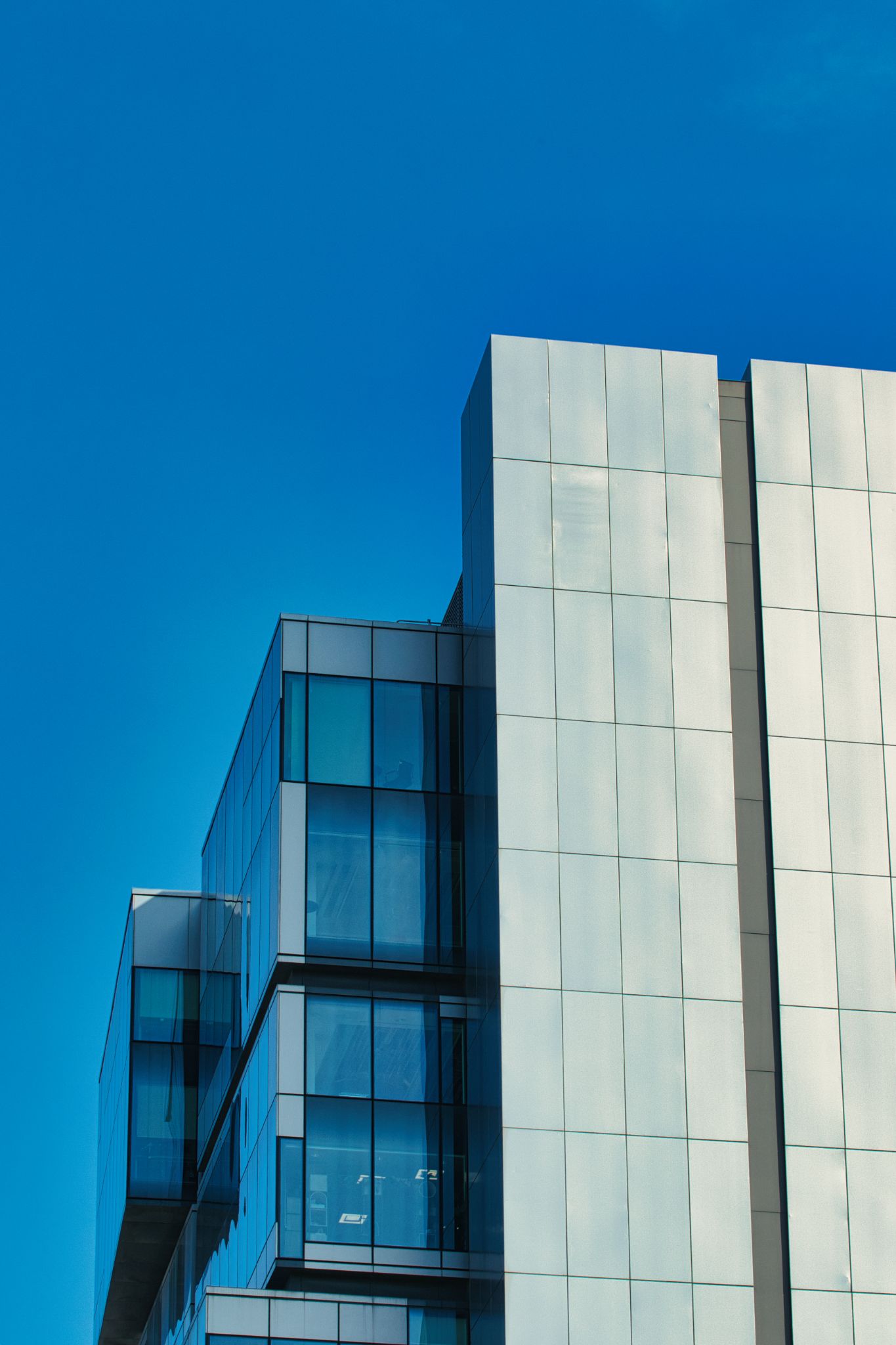 Building Exterior with Glass Windows and Silver Paneling in Manchester, UK.