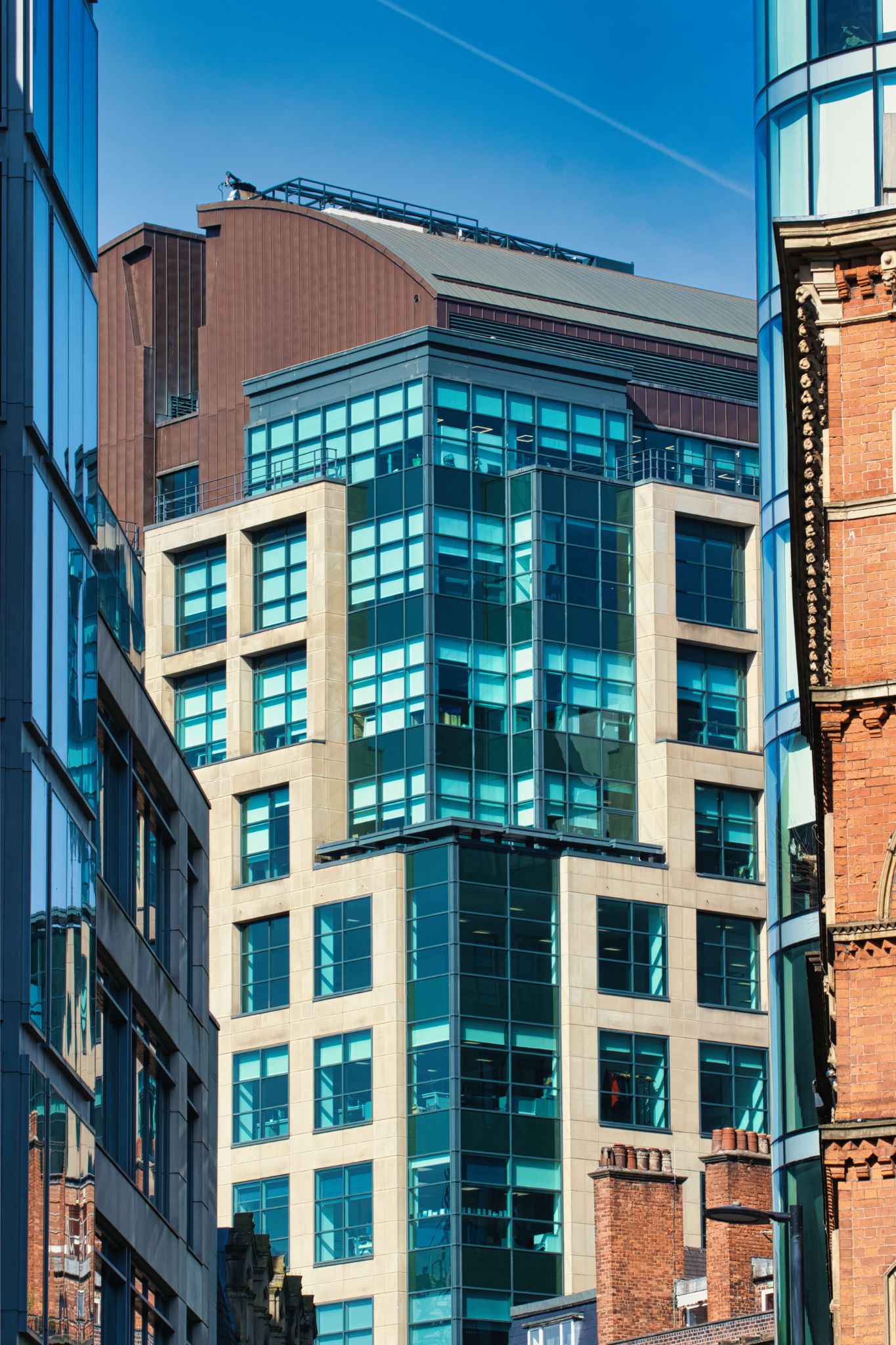 Urban Buildings with Glass and Brick Facades in Manchester, UK.