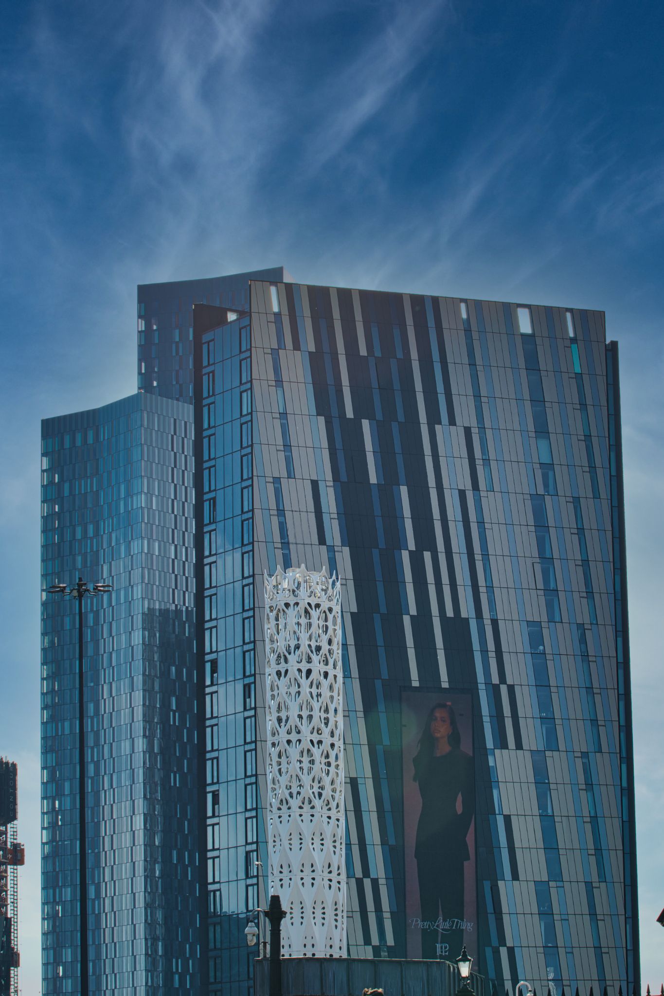 Modern High-Rise Buildings with Decorative Structure and Advertisement in Manchester, UK.