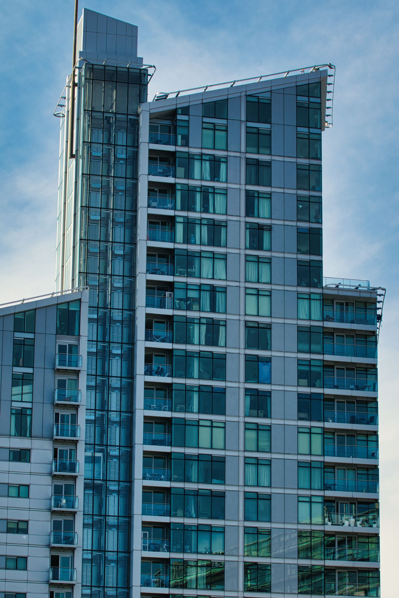 Modern High-Rise Building with Balconies and Glass Windows in Manchester, UK.