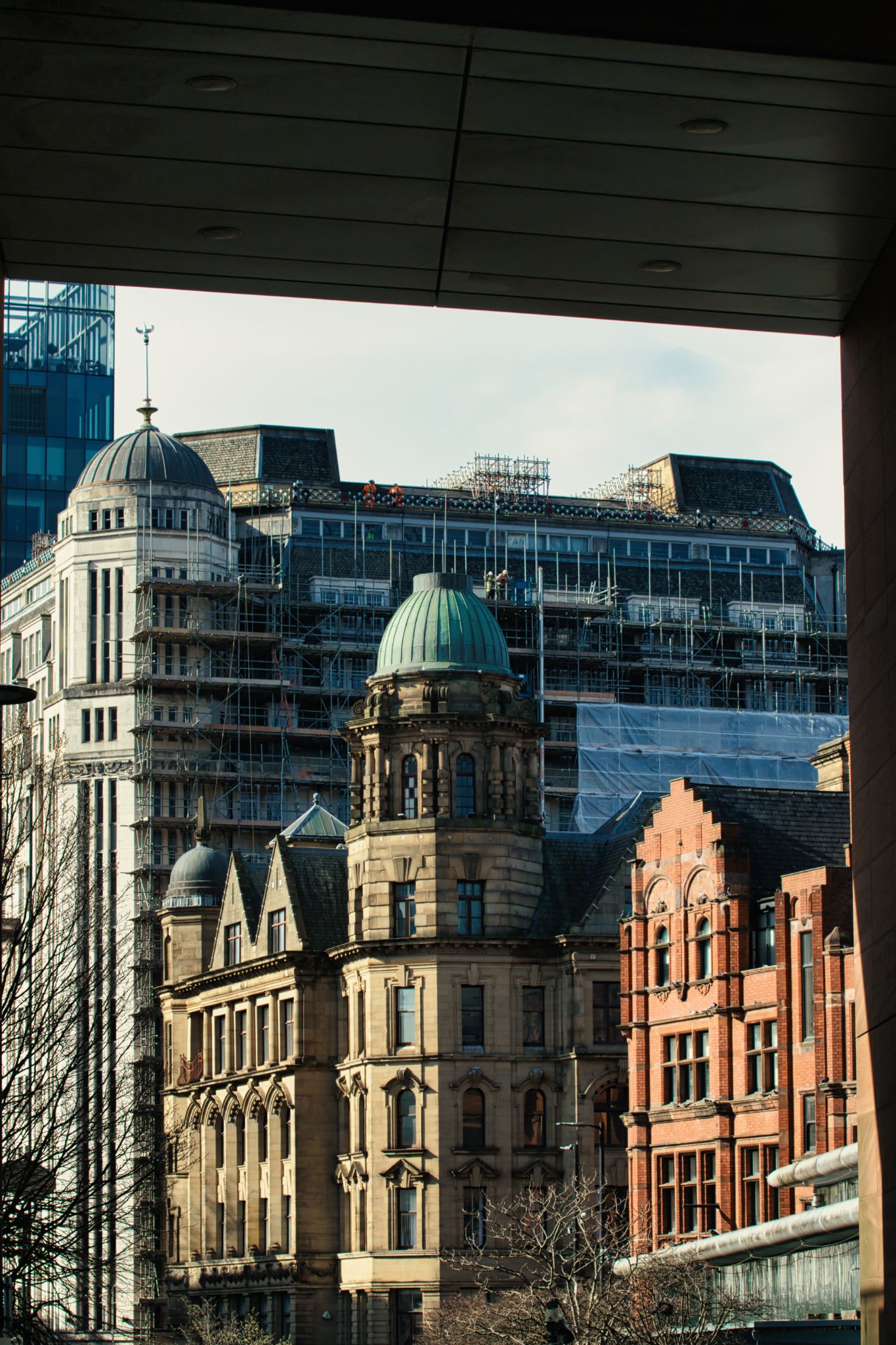 City Buildings Framed by Modern Architecture in Manchester, UK.