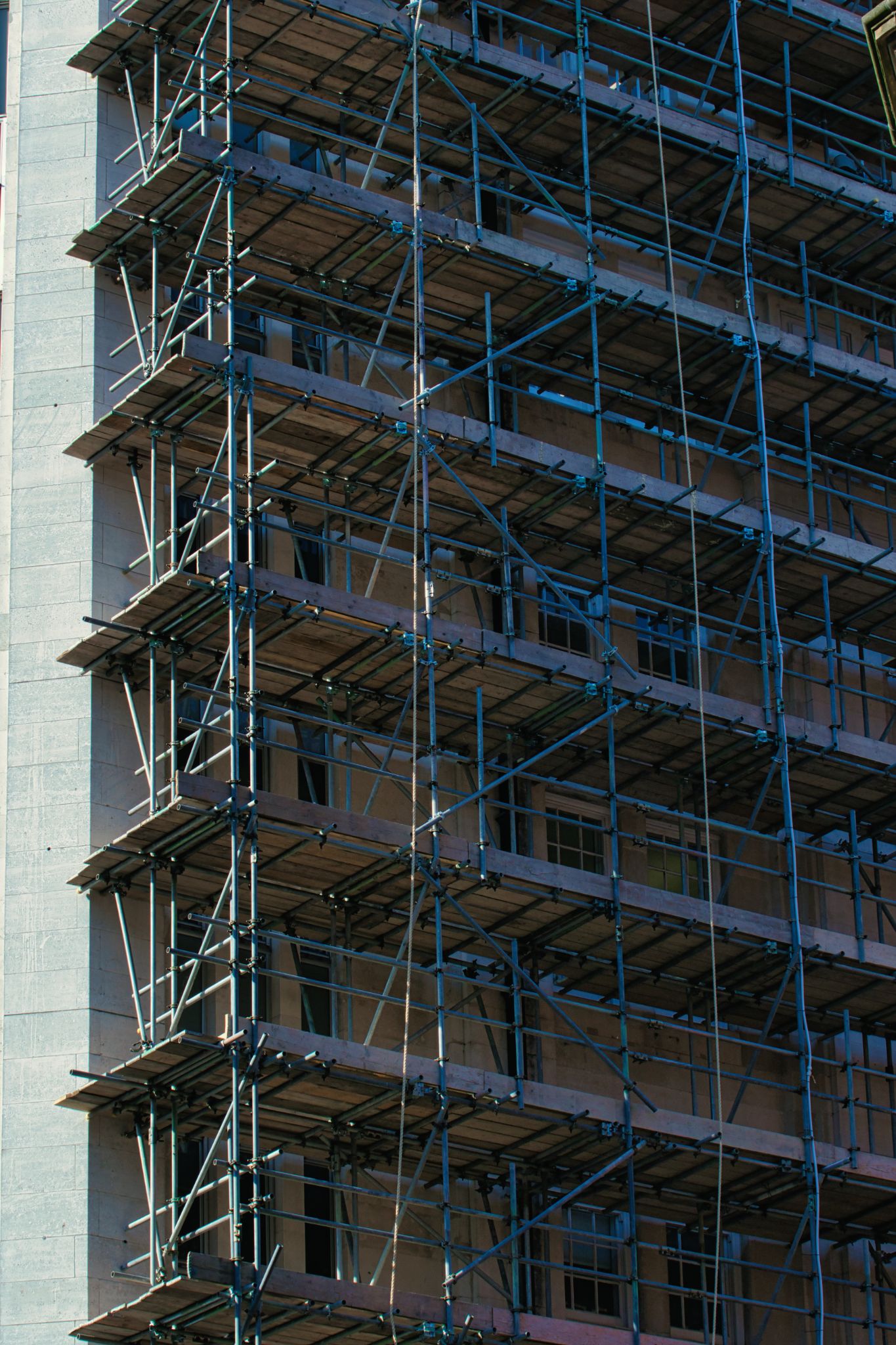 Building Facade with Scaffolding Construction in Manchester, UK.