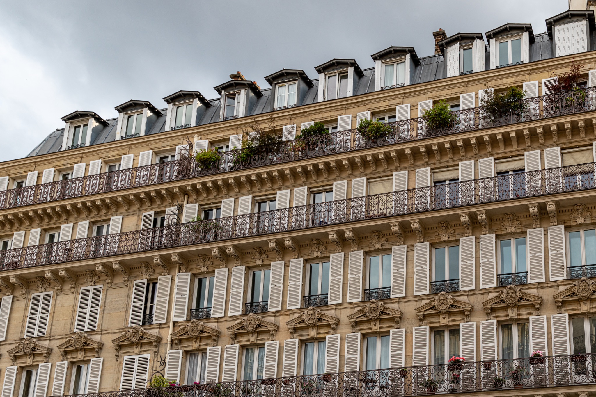 Multi-Story Building Facade with Balconies and Shutters