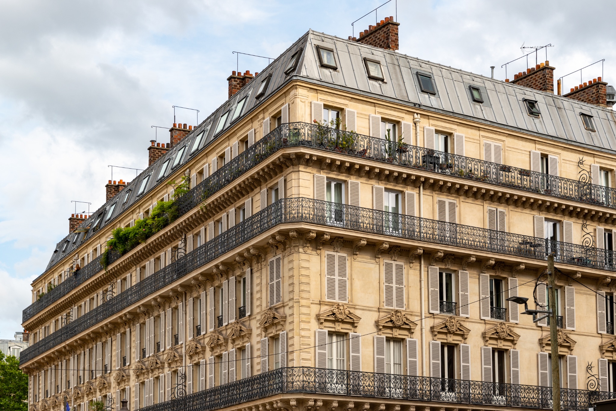 Corner of a Multi-Story Building with Balconies and Shutters