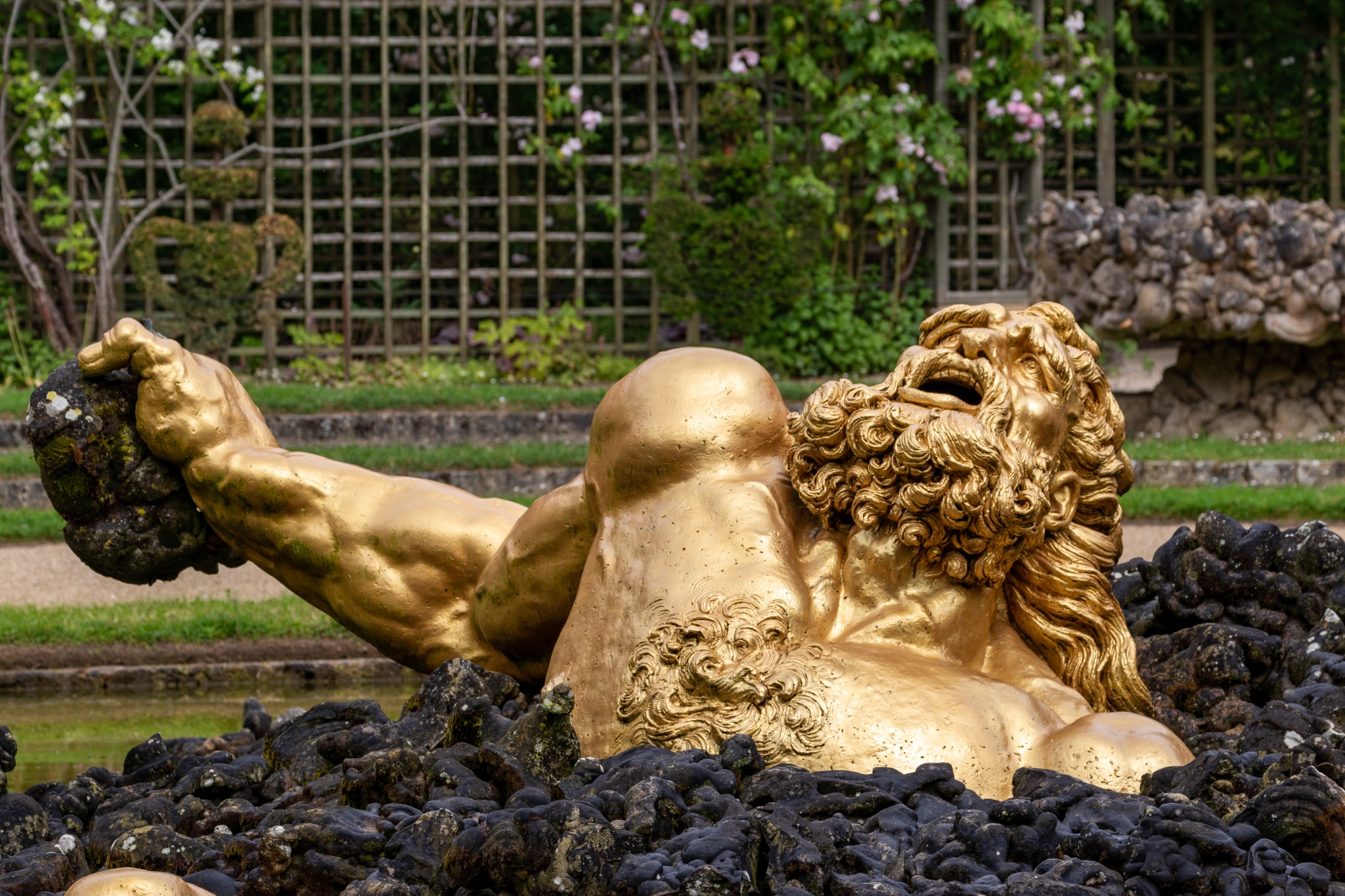 Golden Statue in Garden Fountain at Versailles Gardens, Paris.